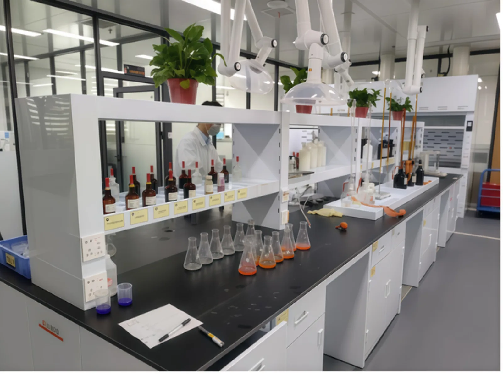 Chemical analysis laboratory with fume hoods, reagent bottles and titration glassware for PCB process control